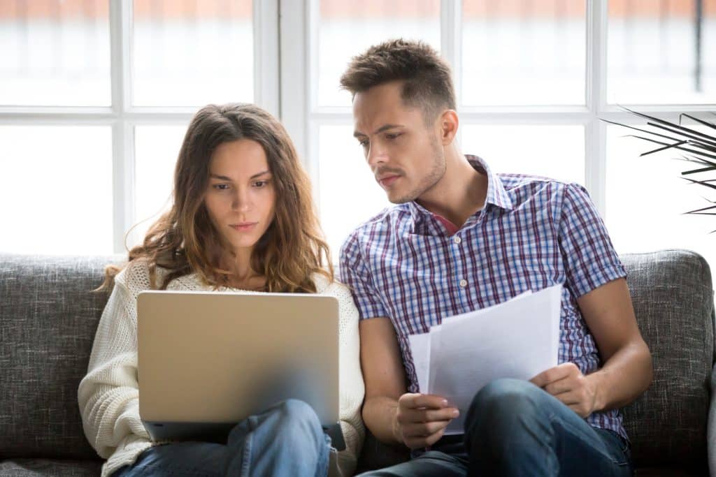 man and woman looking at computer